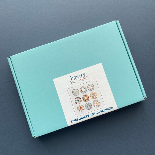 Stitch sampler embroidery kit packaged in a pretty turquoise blue box with labelling