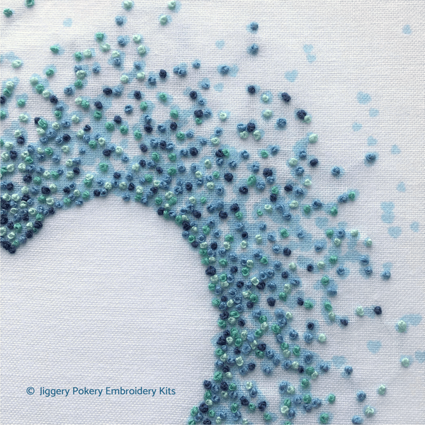 Easy hearts embroidery pattern, close-up showing blue French knots creating a negative space heart