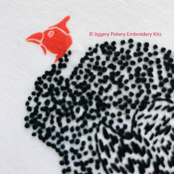 Guinea fowl embroidery pattern close-up of one black and white hen