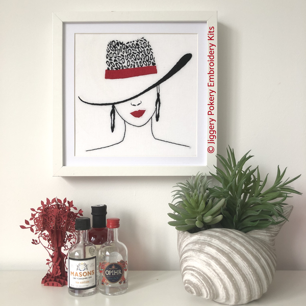 Leopard print embroidery hat kit by Jiggery Pokery framed on wall