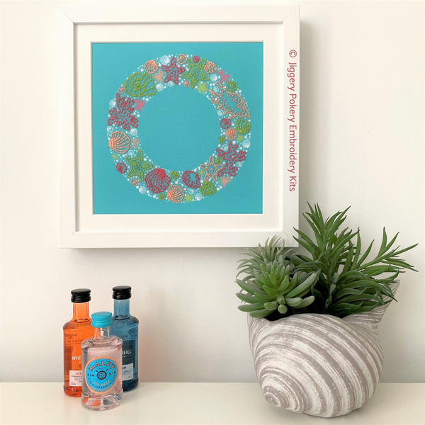 Sea embroidery wreath in frame hanging on wall