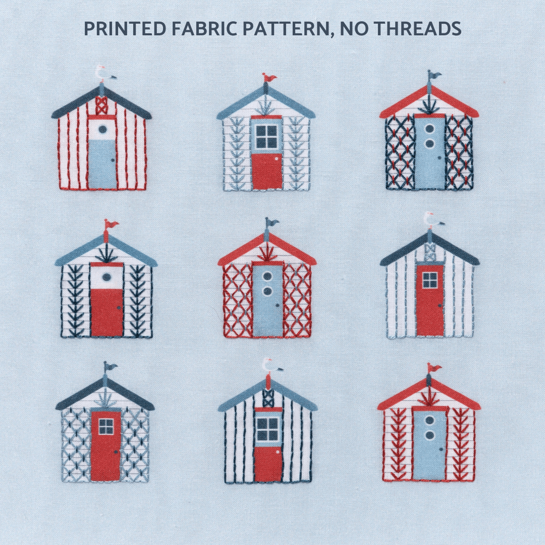 Beach embroidery pattern shows 9 beach huts stitched in dark blue, blue and red against a blue-grey sky