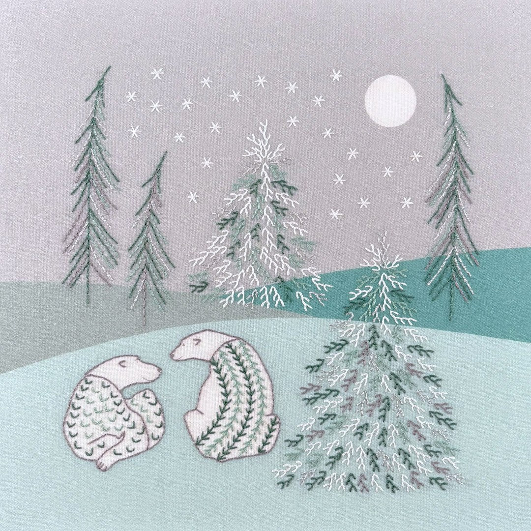 Two polar bears in a winter landscape of soft green and grey with snowy trees and stars under a moonlit sky.