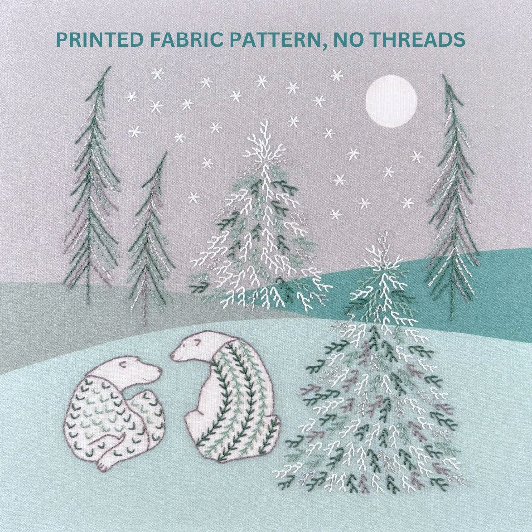 Embroidery pattern showing two polar bears in a forest of snowy trees against a grey sky with white stars and a moon.