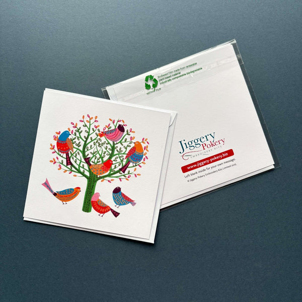 A printed greetings card featuring the birds embroidery design by Jiggery Pokery. Also shows the back of the card and envelope.