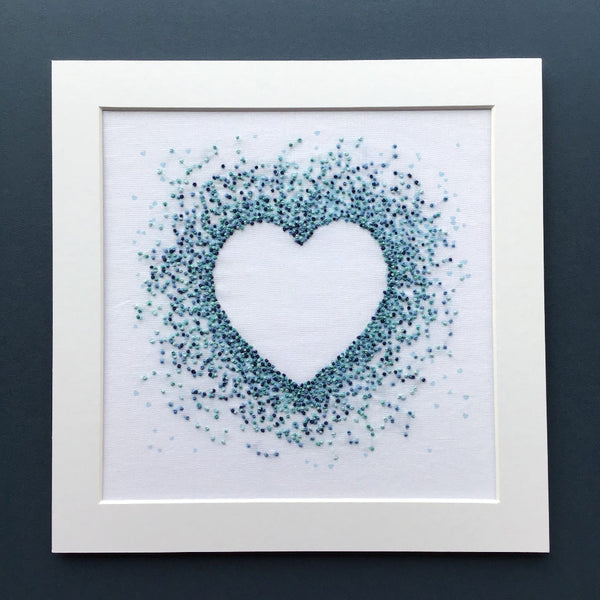 Blue hearts embroidery design shown in square white mount