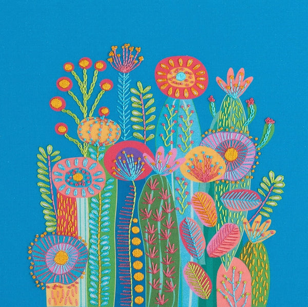 Cactus embroidery kit on blue background showing a group of funky cactus flowers in abstract style