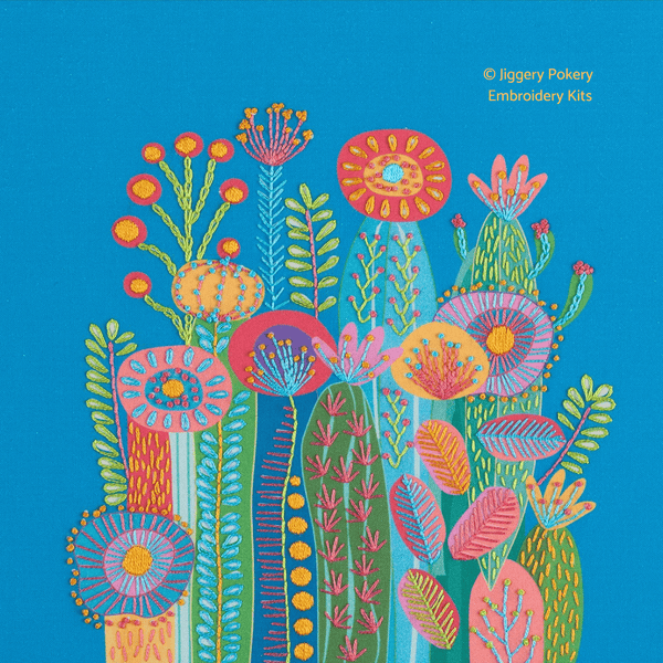 Cactus embroidery kit on blue background showing a group of funky cactus flowers in vibrant colours