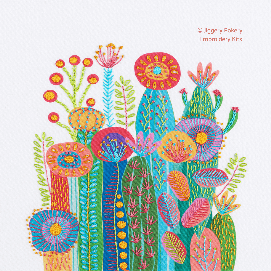 Cactus embroidery kit on white background showing a cluster of brightly coloured cactuses and flowers in abstract style