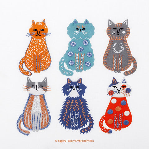 Cats embroidery kit showing 6 cats stitched in blue, orange and grey