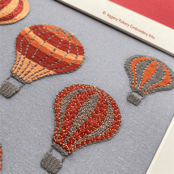 Close-up of hot air balloons embroidery design showing balloons stitched in satin stitch and couching