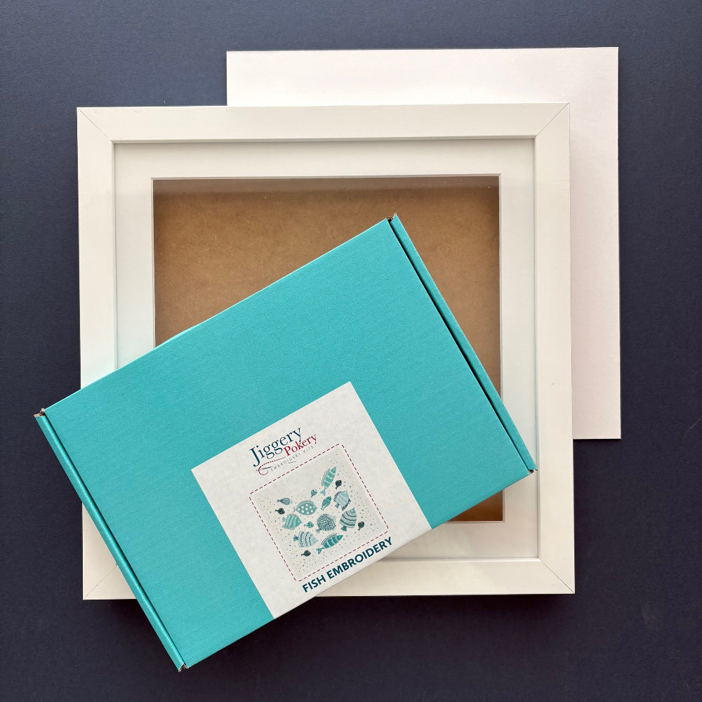 Fish embroidery kit with square white frame and a piece of mountboard cut to size