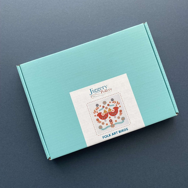 Folk art embroidery kit packaged in a pretty turquoise blue box with labelling