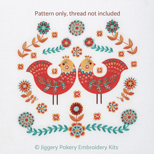 Folk art embroidery pattern showing two birds surrounded by stitched decorations in red, apricot, teal and cream