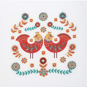 Naive art embroidery kit showing two red folk art birds surrounded by flowers and leaves in apricot and turquoise