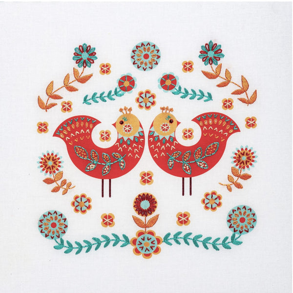 Naive art embroidery kit showing two red folk art birds surrounded by flowers and leaves in apricot and turquoise