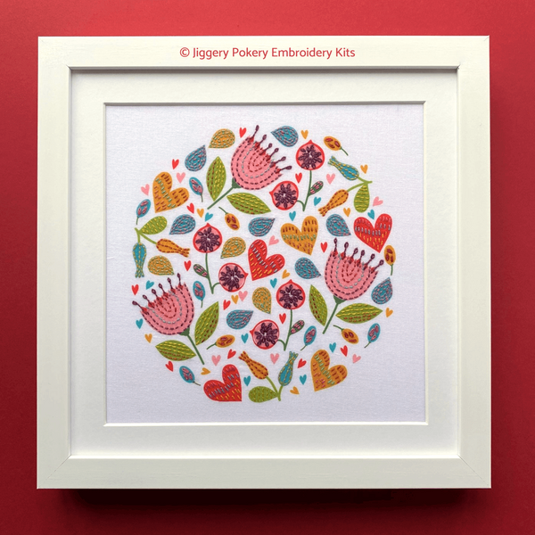 Summer flowers embroidery kit in square white frame on red background