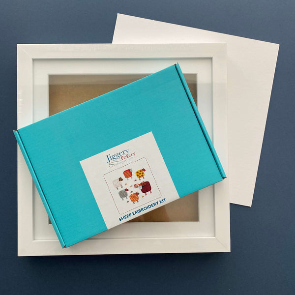 Sheep embroidery kit and square white frame with a piece of mountboard cut to size