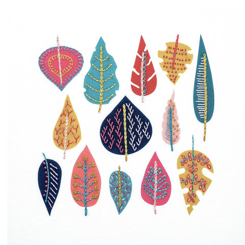 This modern leaf embroidery design comes printed on fabric with a range of simple embroidery stitches added on top. The DMC thread colours are navy blue pink, mustard gold and bluw.