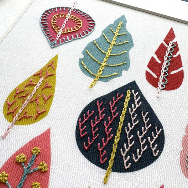 Leaf design stitched onto pre-printed leaf shapes using simple embroidery stitches