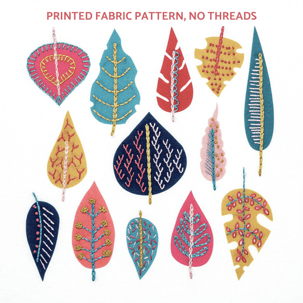 A group of colourful Scandinavian style leaves in blue, mustard and pink stitched with simple embroidery stitches.