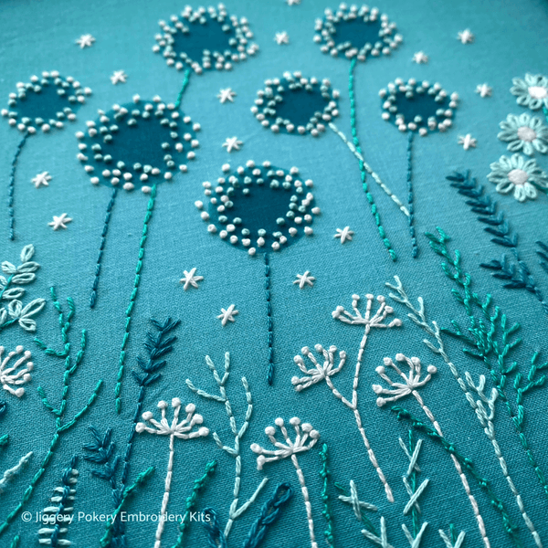 Close-up of 7 dandelion flowers on the modern embroidery flowers pattern.