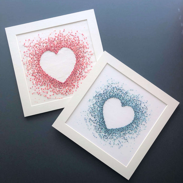 Hearts embroidery designs showing a negative space heart created by French knots in shades of pink or blue threads.