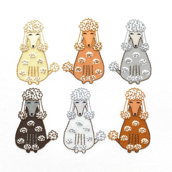 Poodles embroidery kit showing 6 poodles in cream, light brown, grey, dark brown, light grey and brown poodles embroidered with simple embroidery stitches