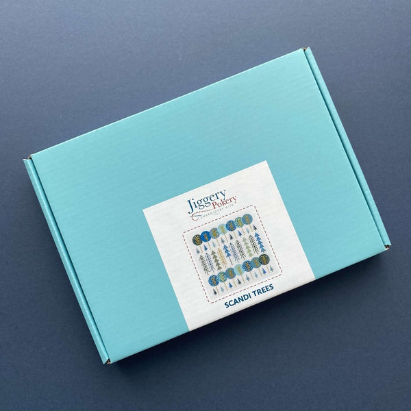 Scandinavian trees embroidery kit packaged in a pretty turquoise blue box with labelling