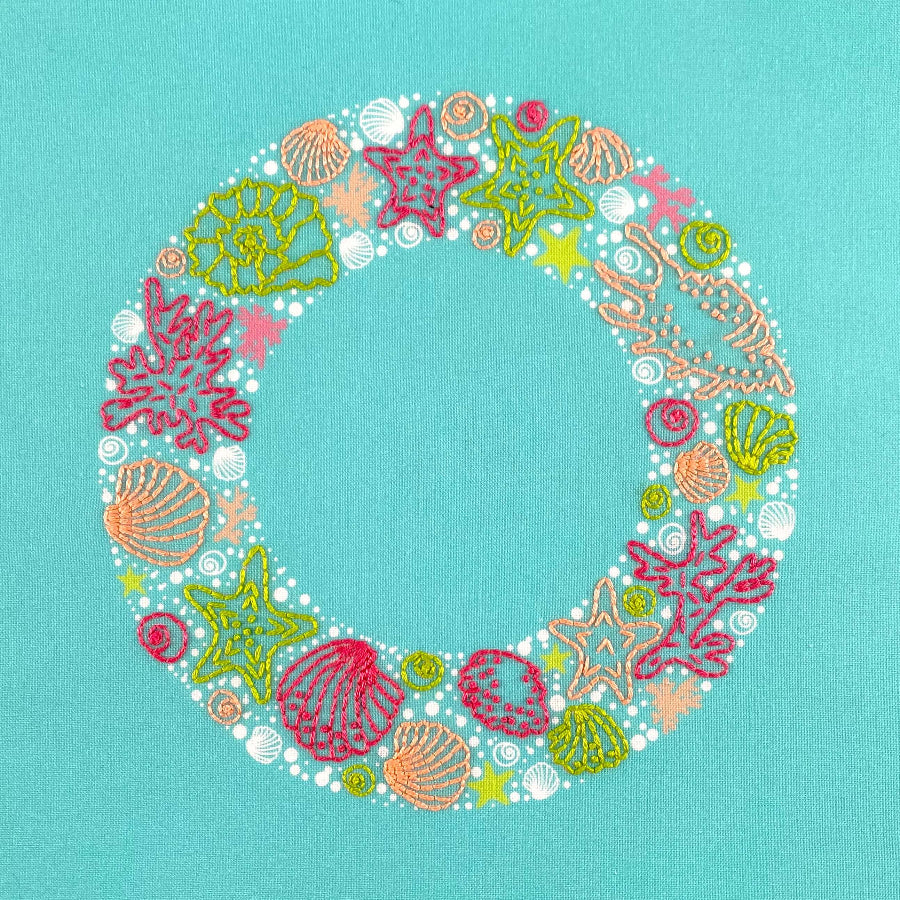Seaside embroidery wreath of sea shells, star fish, seaweed and bubbles in bright pink, green and coral colours