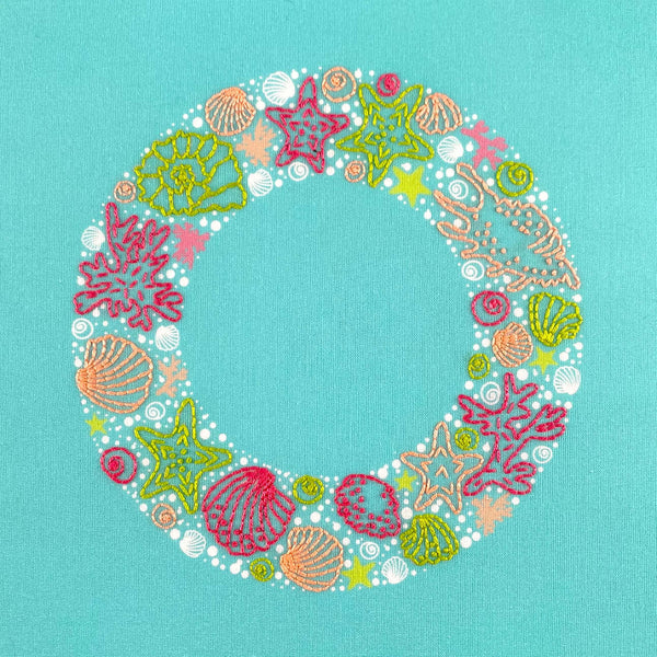 Seaside embroidery wreath of sea shells, star fish, seaweed and bubbles in bright pink, green and coral colours