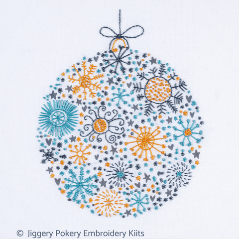 Simple Christmas embroidery kit showing a festive ball in dark grey, teal and orange gold colours