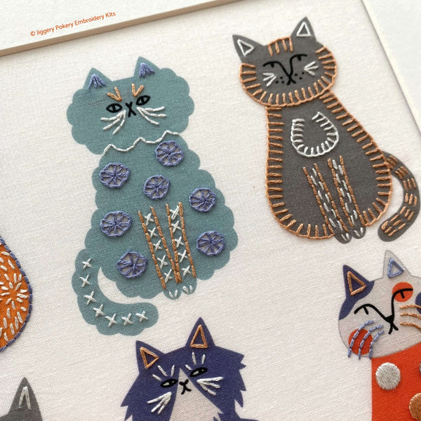Cat embroidery showing a blue cat and a grey cat embroidered with blanket stitch