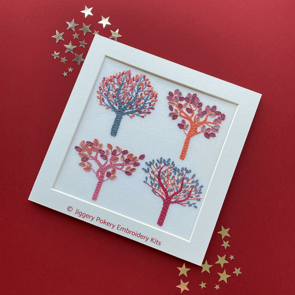 Autumn embroidery pattern mounted, shown on red background with stars