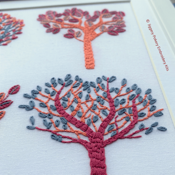 Autumn trees embroidery pattern close-up of two trees stitched in fall colors