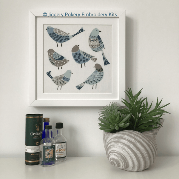 Simple bird embroidery framed on wall