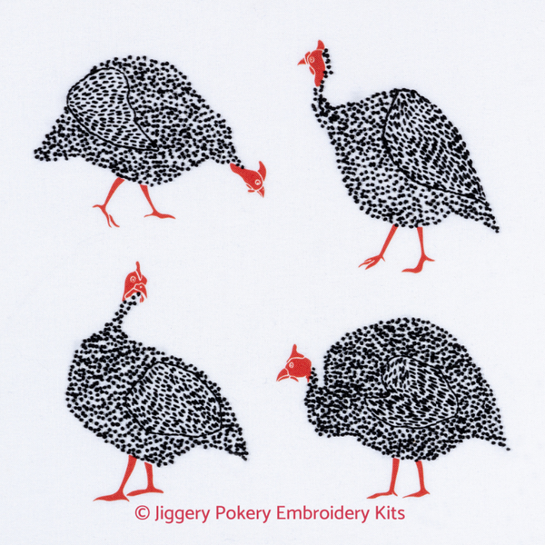 Bird embroidery kit showing four black and white guinea fowl with red necks