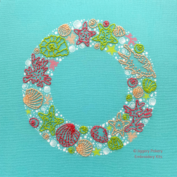 Seaside embroidery wreath of sea shells, star fish, seaweed and bubbles in bright pink, green and coral colours