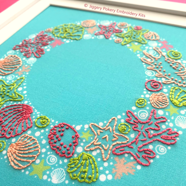 Close-up of seashells embroidery wreath pattern in frame