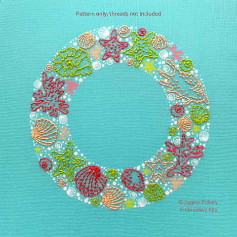 Seaside wreath embroidery pattern showing seashells, starfish, seaweed and bubbles in green, coral and pink