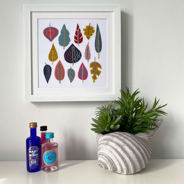 Modern leaf embroidery design framed hanging on wall