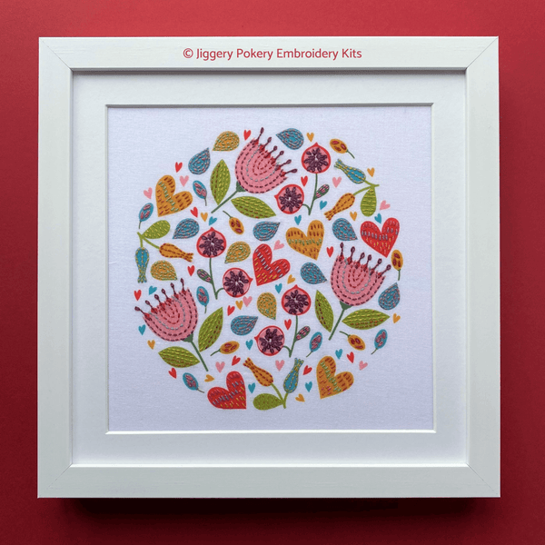 Embroidery flowers for beginners showing colourful flowers, hearts and leaves, framed on red background