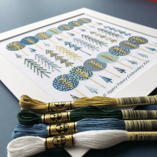Simple trees embroidery with DMC threads in gold, blue, dark green and white,