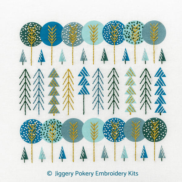 Scandinavian trees embroidery kit showing trees in navy, aqua, gold and green